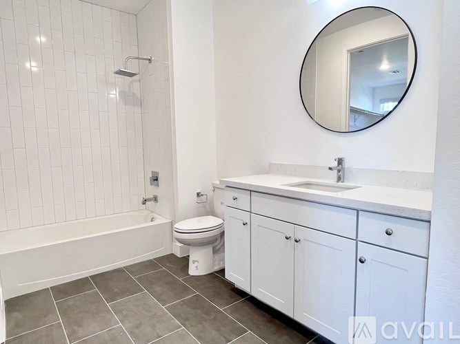 A bathroom with a white toilet, sink, and bathtub.