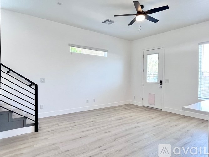 A spacious room with a ceiling fan and a window.