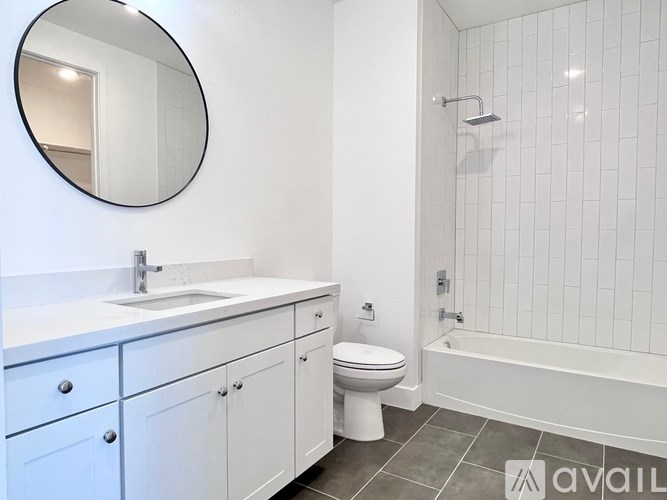 A bathroom with a white sink, toilet, and bathtub.