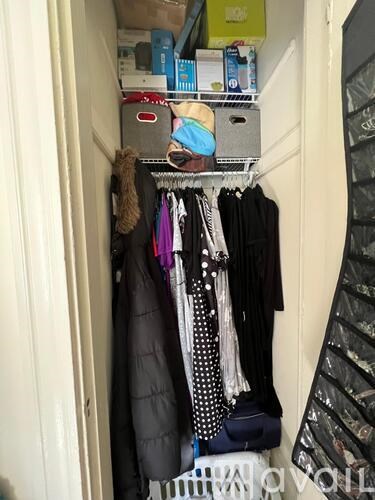 A closet with a variety of clothes hanging up.