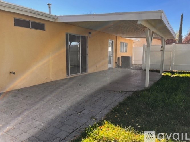 A house with a covered patio area and a fence.