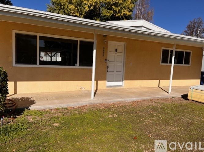 A room with a concrete floor and a ceiling fan.