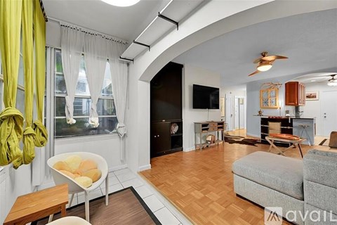 A living room with a grey couch and a yellow chair.