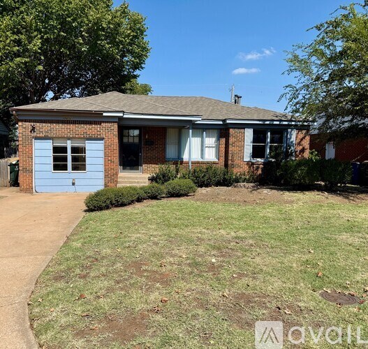 A house with a blue garage door is for sale.