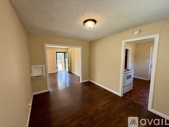A room with wooden floors and a white ceiling with a light fixture.