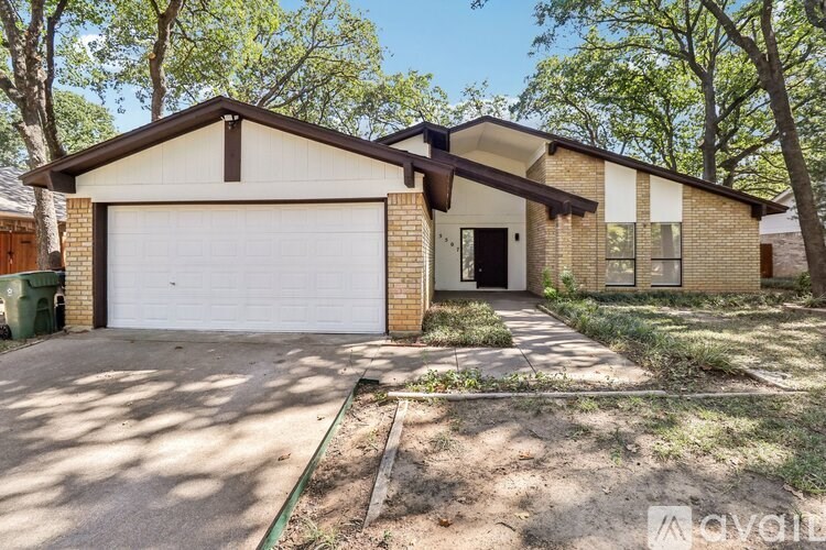 A house with a white garage door and a brown roof.