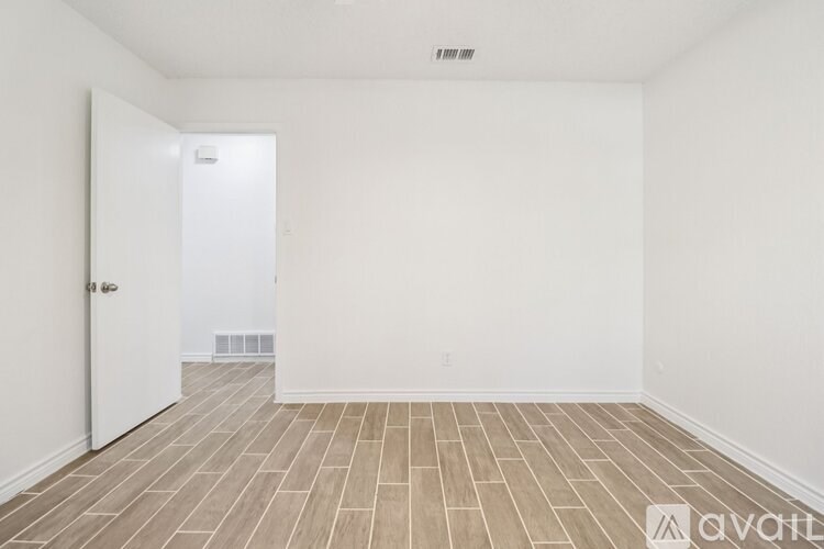 A room with a door and a tiled floor.