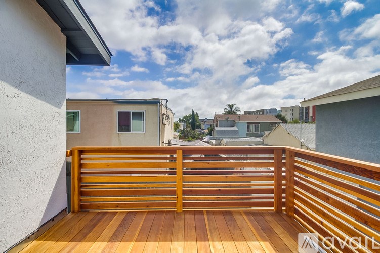 A wooden deck with a gate leads to a building.