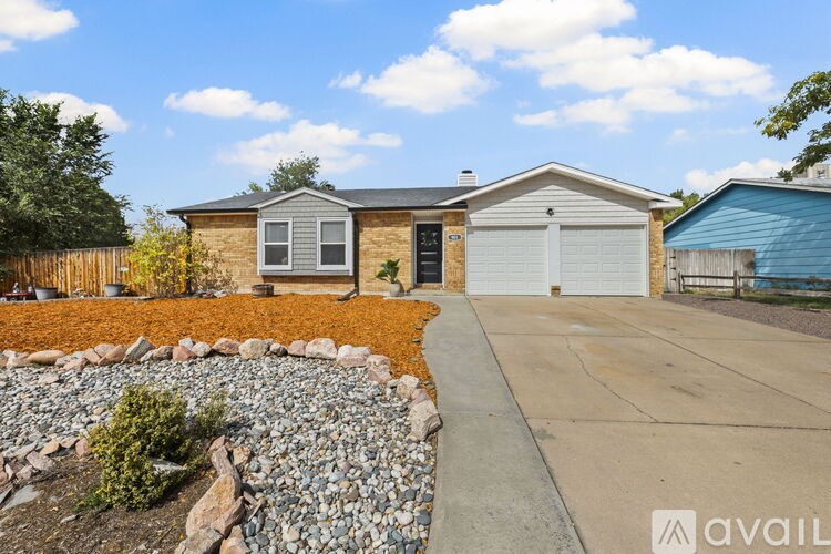 A house with a garage and a gravel garden bed in front.