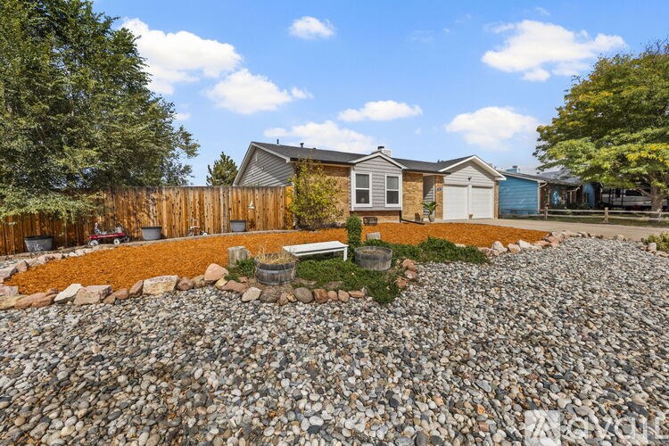 A house with a gravel yard in front.