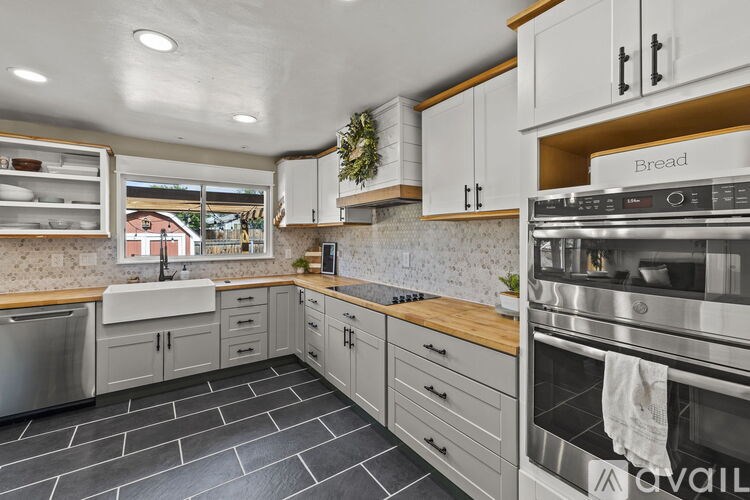 A modern kitchen with a stainless steel oven and wooden countertops.