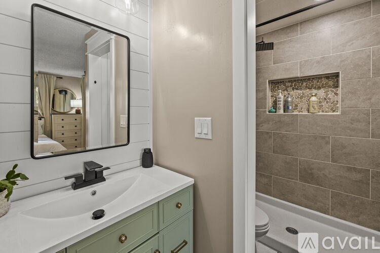 A bathroom with a white sink and a mirror above it.