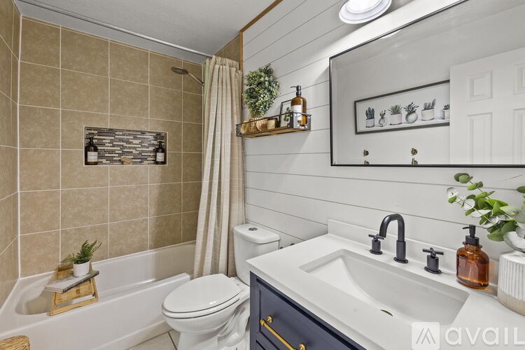 A bathroom with a white toilet, a white sink, and a white bathtub.