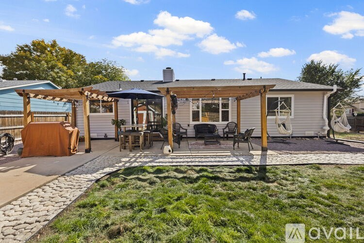 A house with a covered patio and a stone walkway.