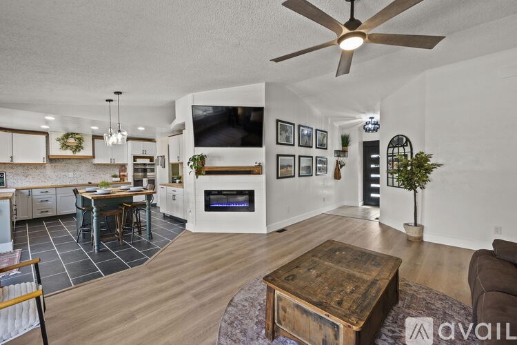 A living room with a ceiling fan and a wooden coffee table.