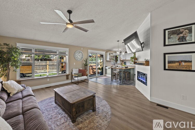 A living room with a brown leather couch and a wooden coffee table.