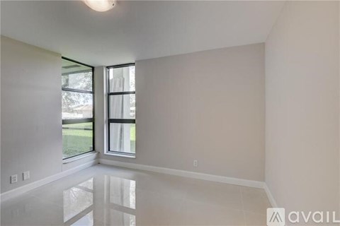 A room with a large window and a white floor.