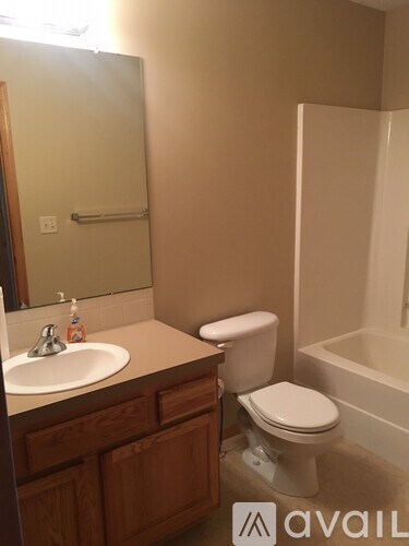 A bathroom with a toilet, sink, and bathtub.