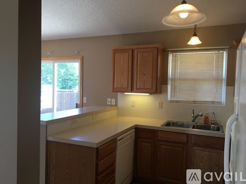 A kitchen with wooden cabinets and a white refrigerator.