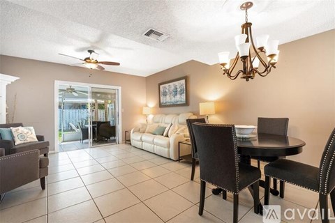 A living room with a dining table and chairs.
