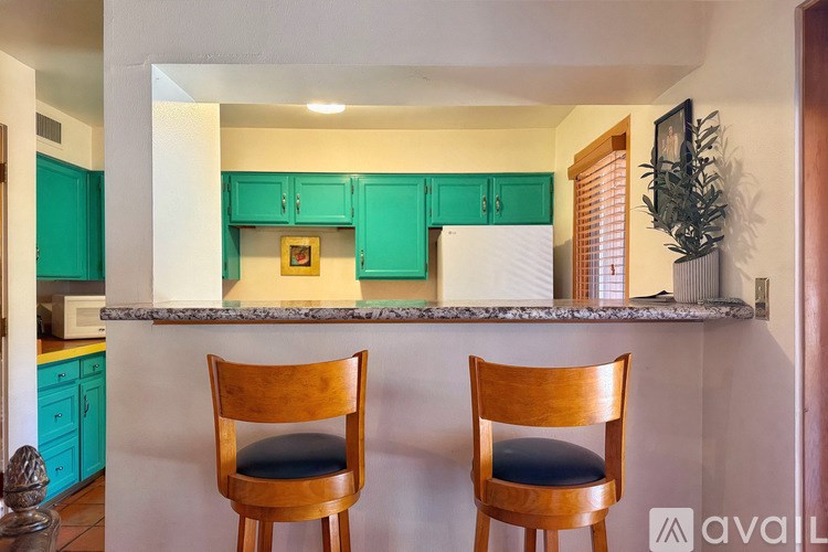 Two wooden chairs are placed in front of a counter.