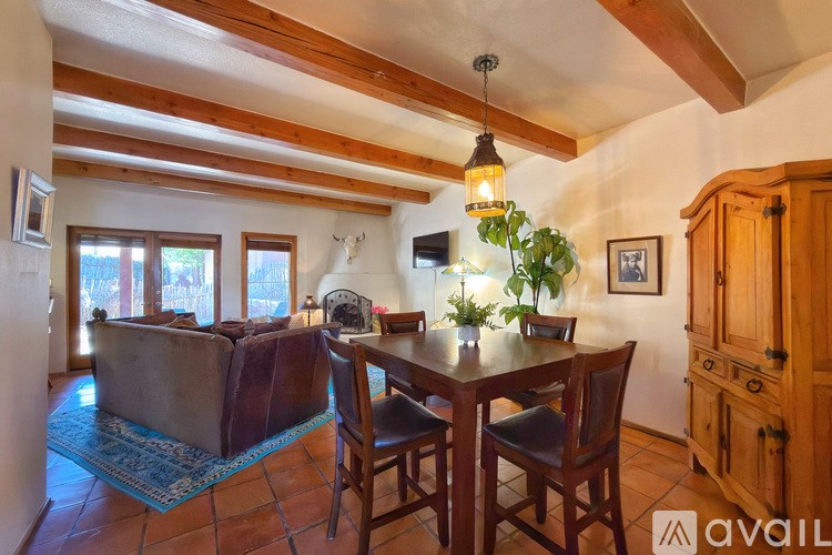 A dining room with a wooden table and chairs.