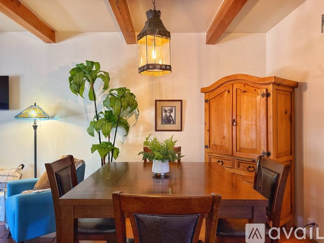 A dining room with a wooden table and chairs.