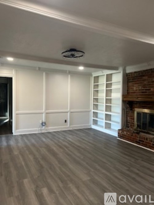 A room with a fireplace and a brick wall.