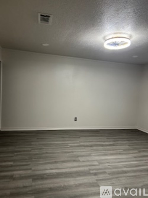 A room with a grey floor and a white wall.