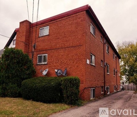 A red brick building with a satellite dish on the roof.