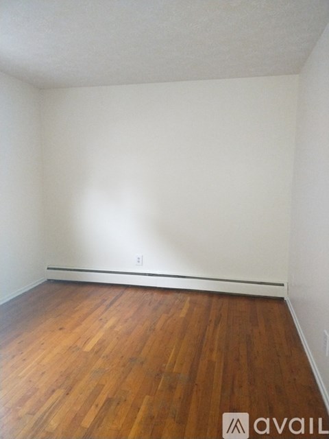 A room with wooden floors and white walls.