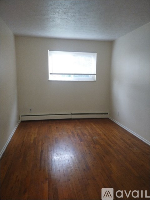 A room with wooden floors and a window.