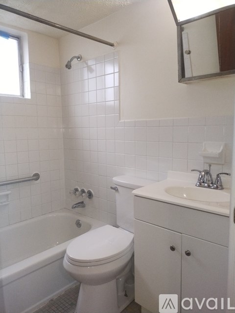 A white toilet sits next to a sink in a bathroom.