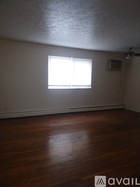 A room with wooden floors and a window.