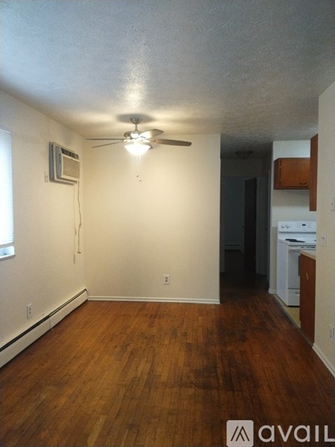 A room with a ceiling fan and a window.