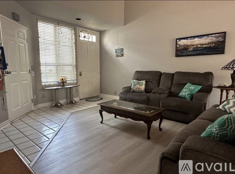 A living room with a grey couch and a coffee table.