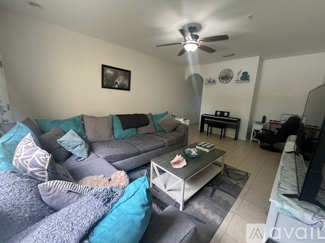 A living room with a grey couch and a coffee table.