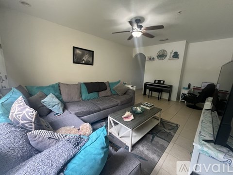 A living room with a grey couch and a coffee table.