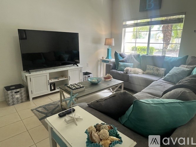 A living room with a couch, a television, and a coffee table.
