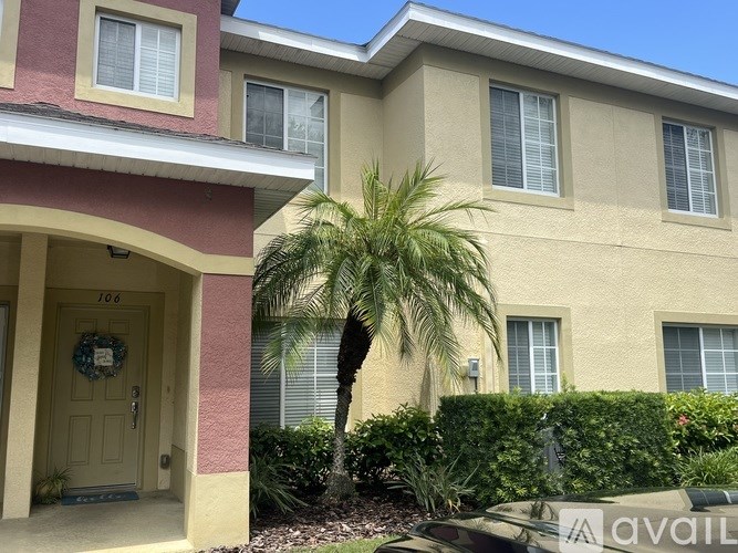 A house with a brown door and a wreath on it.