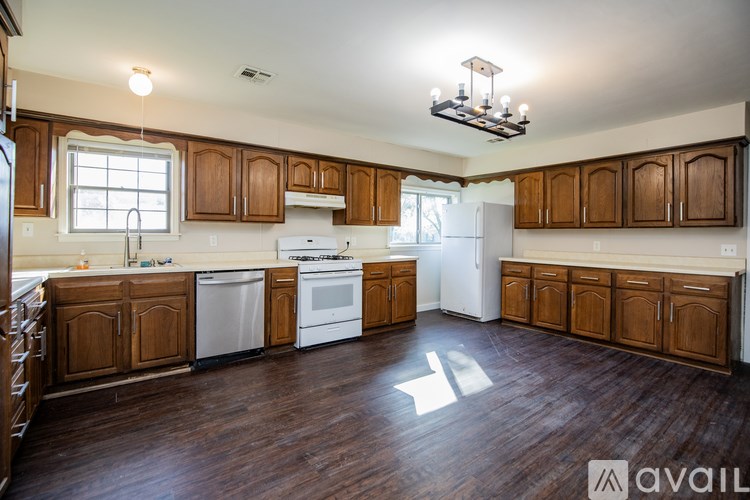 A kitchen with wooden cabinets and a white fridge.