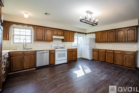 A kitchen with wooden cabinets and a white fridge.