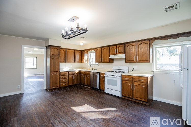 A kitchen with wooden cabinets and white appliances.