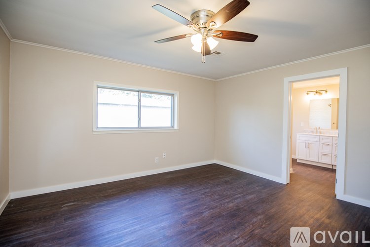 A room with a ceiling fan and a window.