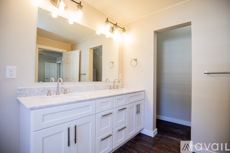 A bathroom with a vanity and a mirror.