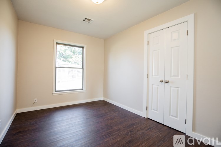 A room with a white door and a window.