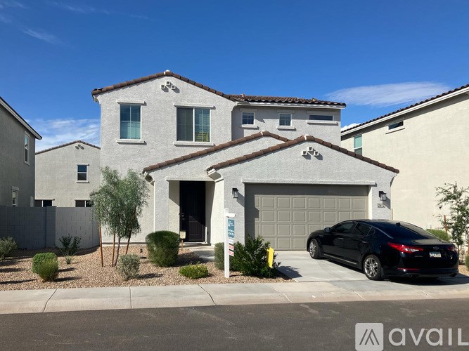A house with a black car parked in front.