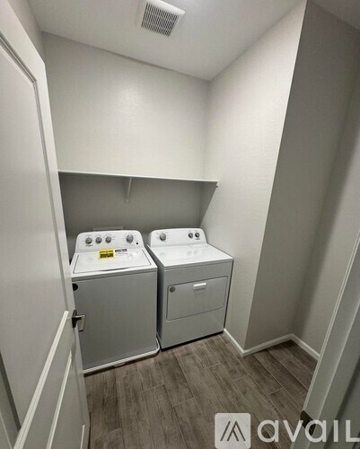A small laundry room with two front loading washing machines.