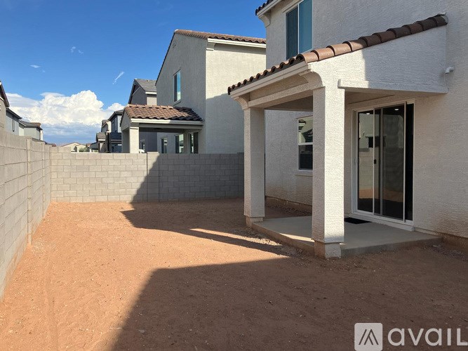 A house with a patio and a wall in the background.