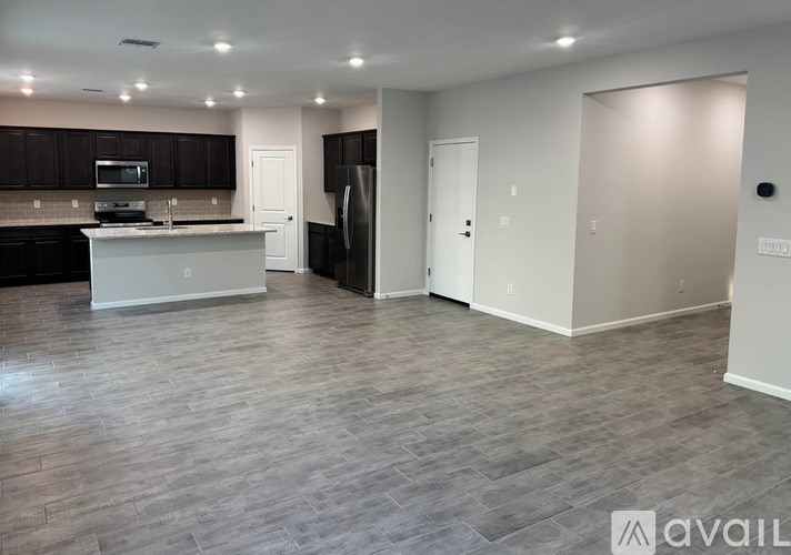 A kitchen with dark brown cabinets and a white island.